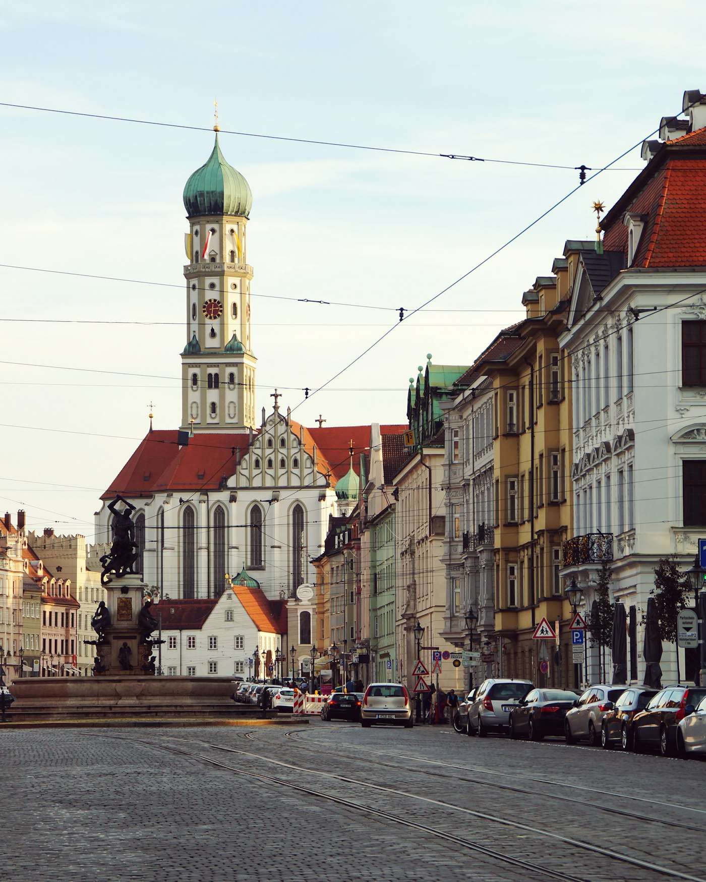 The Herkulesbrunnen and St. Ulrich's basilica on Augsburg's Maximilianstraße