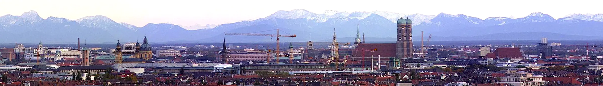 Munich's old-town towers with the Alps behind, the Frauenkirche at the center